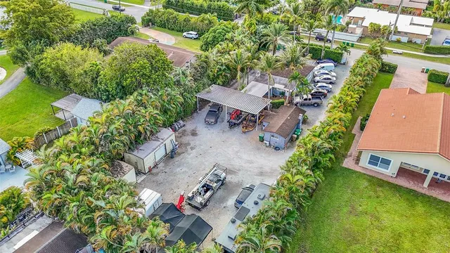 an aerial view of a house with a garden and trees