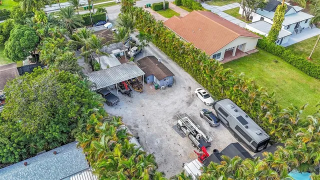 an aerial view of residential houses with outdoor space and swimming pool