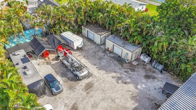 an aerial view of a houses with a yard
