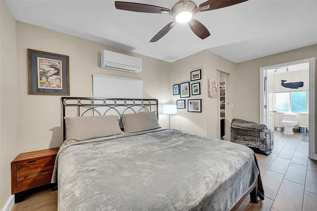 a bedroom with a large bed and a chandelier