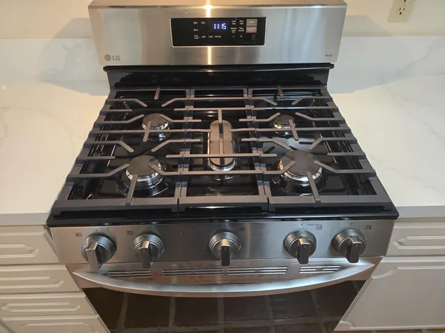 a close view of a stove a microwave and table