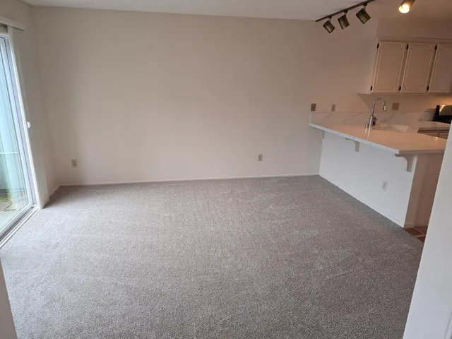 a view of a kitchen with a sink and cabinets