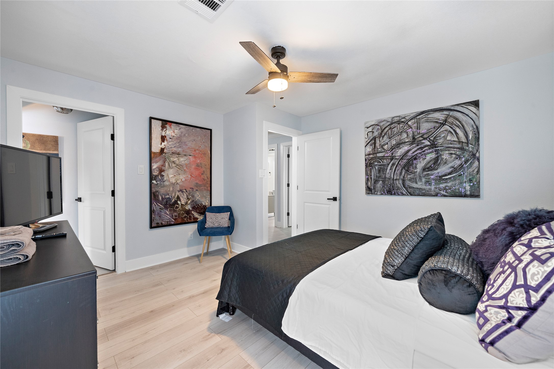 3502 Ruth Street Houston, TX 77004 - Photo 4 of 20 a bedroom with a bed and a chandelier