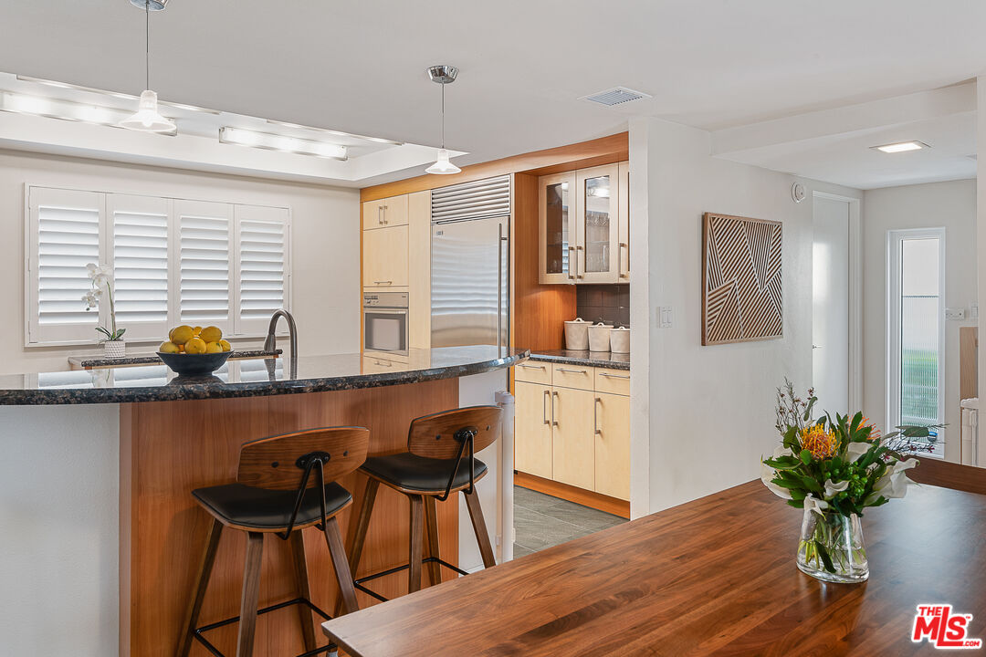 13214 Fiji Way, Unit P Marina del Rey, CA 90292 - Photo 11 of 41 a dining room with furniture and wooden floor
