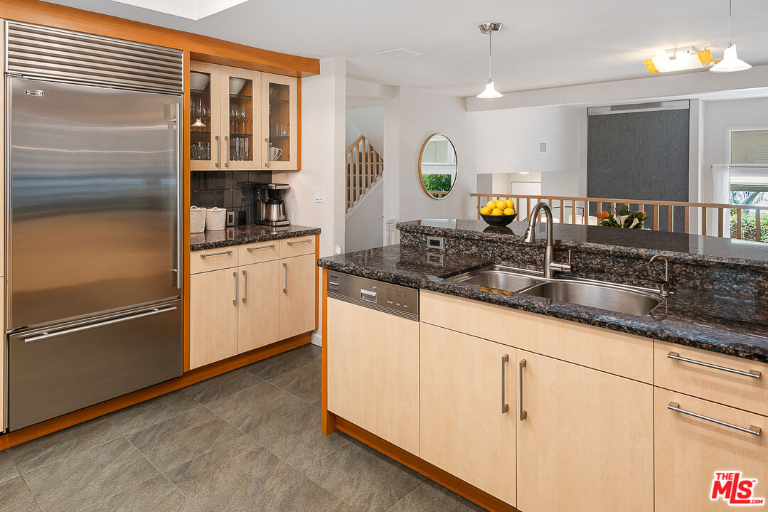 13214 Fiji Way, Unit P Marina del Rey, CA 90292 - Photo 12 of 41 a kitchen with granite countertop a sink stainless steel appliances and cabinets
