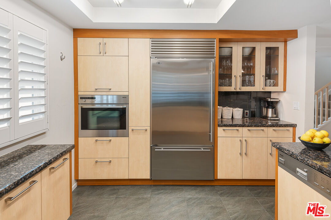 13214 Fiji Way, Unit P Marina del Rey, CA 90292 - Photo 15 of 41 a kitchen with granite countertop a refrigerator and a stove top oven