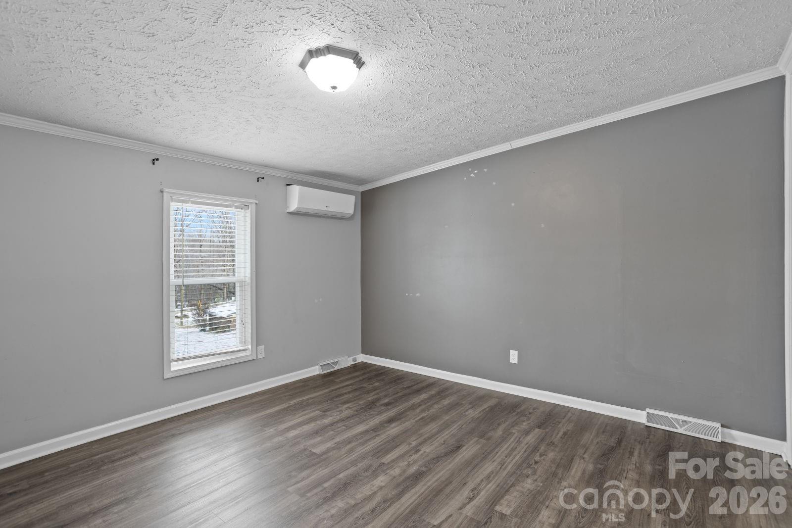 4855 Talley Road Walkertown, NC 27051 - Photo 20 of 45 a view of an empty room with wooden floor and a window