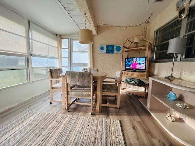 8506 Southwest 93rd Street, Unit B Ocala, FL 34481 - Photo 8 of 8 a living room with furniture a flat screen tv and floor to ceiling window