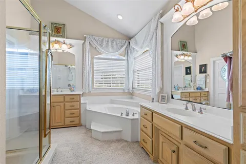 a bathroom with a tub sink and mirror