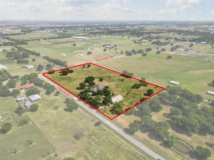 an aerial view of a house with a yard and lake view