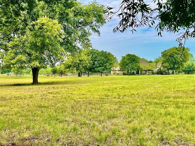 a view of yard with swimming pool and green space