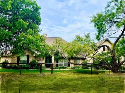 a garden with trees in front of it