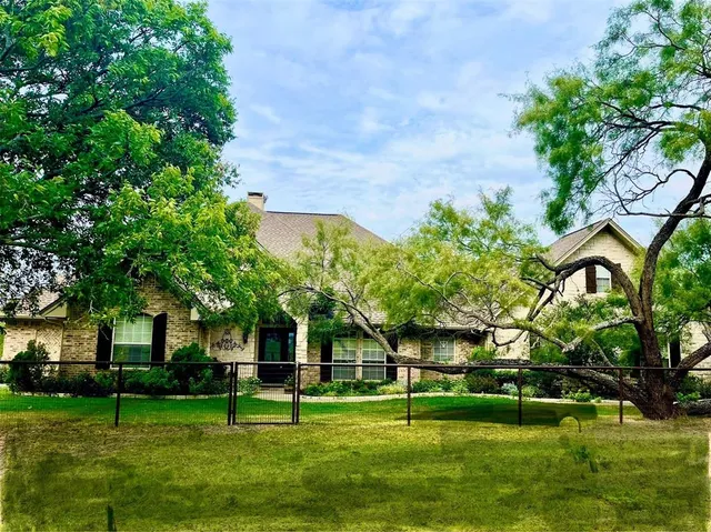 a garden with trees in front of it