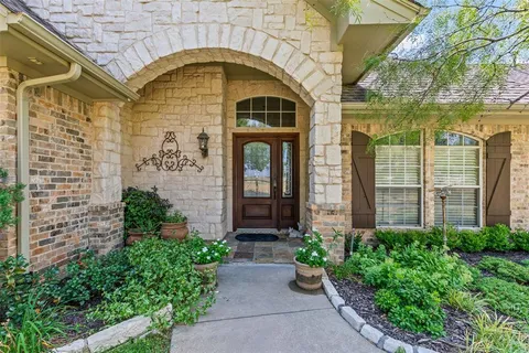 a front view of a house with plants