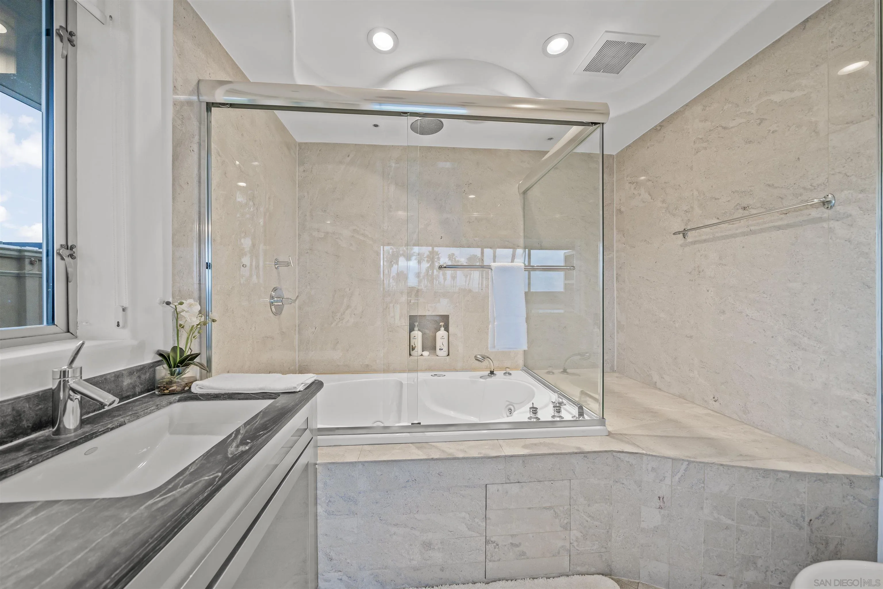 2999 Ocean Front Walk, Unit 2 San Diego, CA 92109 - Photo 15 of 25 a bathroom with a granite countertop sink mirror and a bath tub