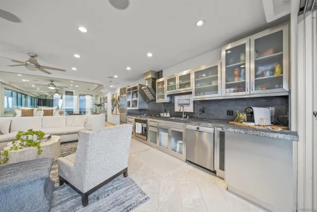a kitchen with stainless steel appliances granite countertop a stove and a refrigerator