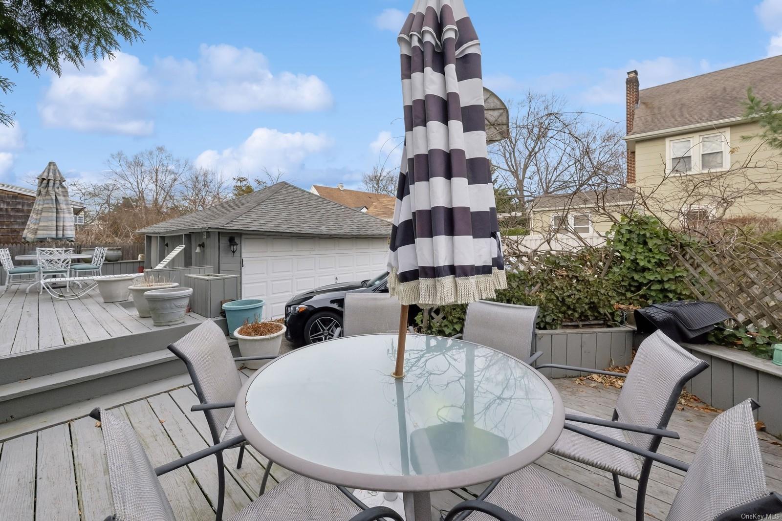 32 Harvard Avenue Hewlett, NY 11557 - Photo 34 of 42 Wooden terrace featuring a garage