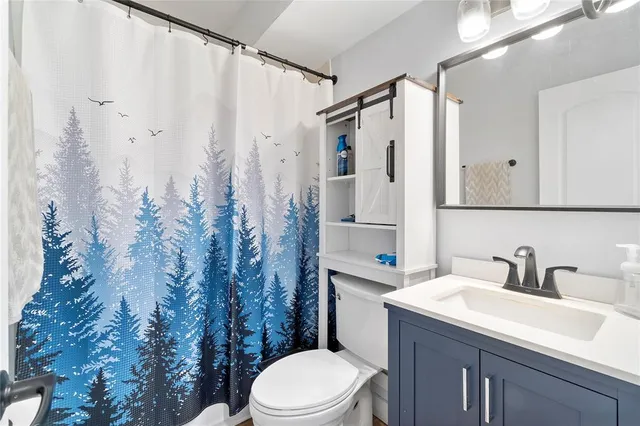 a bathroom with a sink toilet and shower