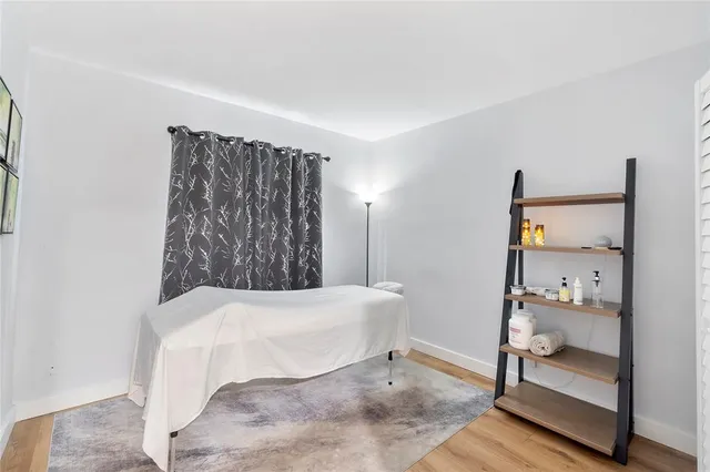 a bedroom with a bed and large mirror