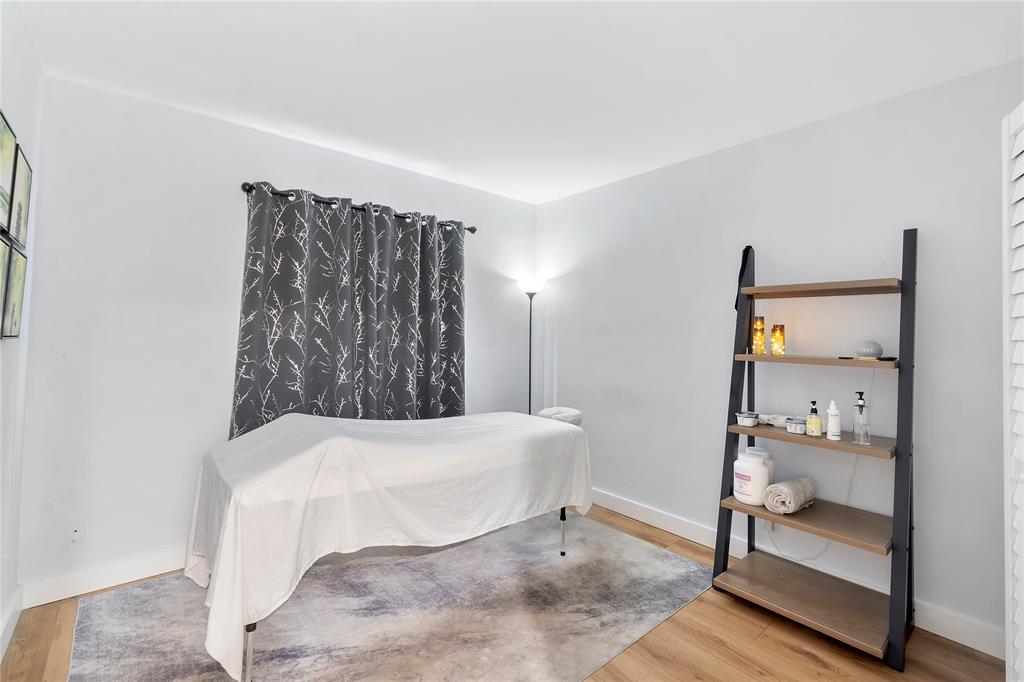 3030 Northeast 5th Terrace, Unit 1 Wilton Manors, FL 33334 - Photo 12 of 22 a bedroom with a bed and large mirror