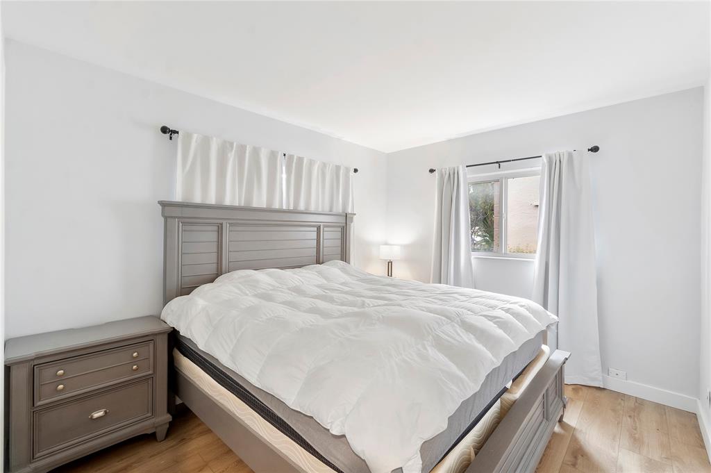 3030 Northeast 5th Terrace, Unit 1 Wilton Manors, FL 33334 - Photo 8 of 22 a bedroom with a bed and a dresser