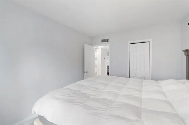 a large white bed in a white room