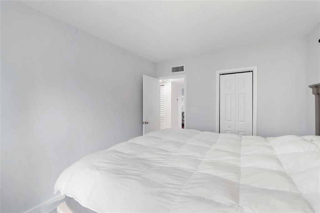 3030 Northeast 5th Terrace, Unit 1 Wilton Manors, FL 33334 - Photo 9 of 22 a large white bed in a white room