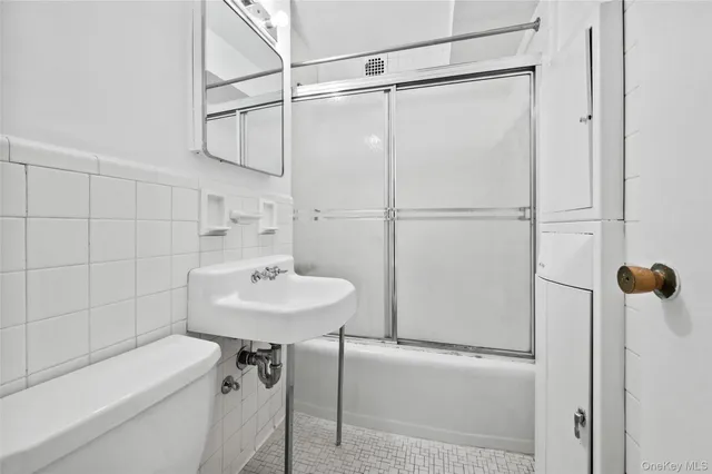 a bathroom with a sink a shower and a mirror