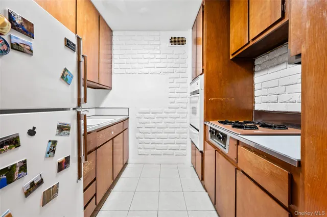 a hallway with stove and white cabinets