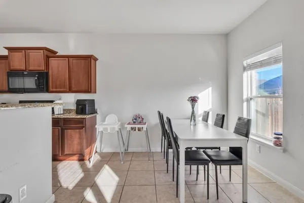 a dining room with furniture and window
