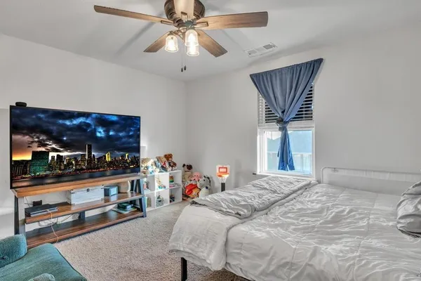 a bedroom with a bed and a flat screen tv