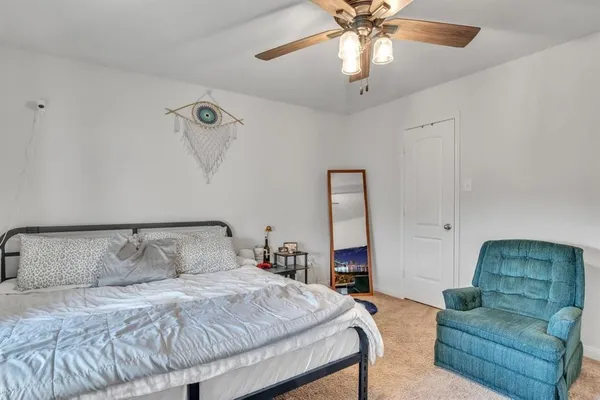 a bedroom with bed and a chandelier