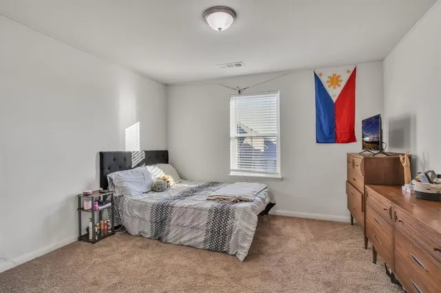 a bedroom with furniture and a window