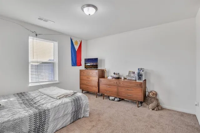 a bedroom with furniture and a window