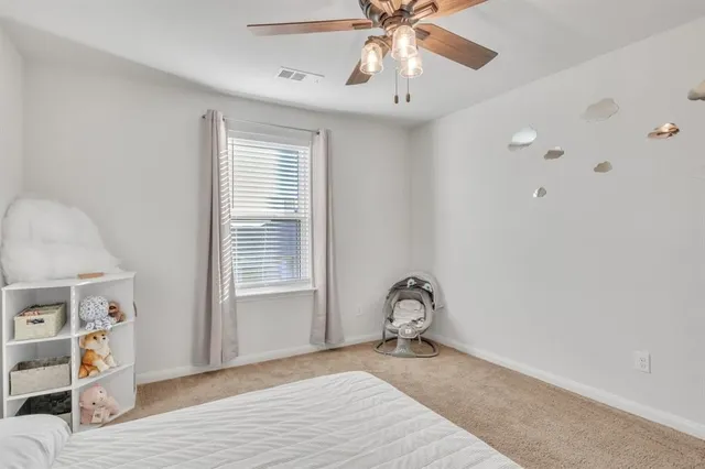 a view of a bedroom with wooden floor and workspace