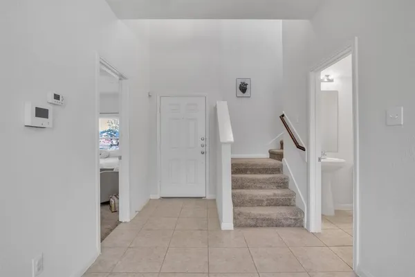 a view of entryway and hall with a view of bathroom
