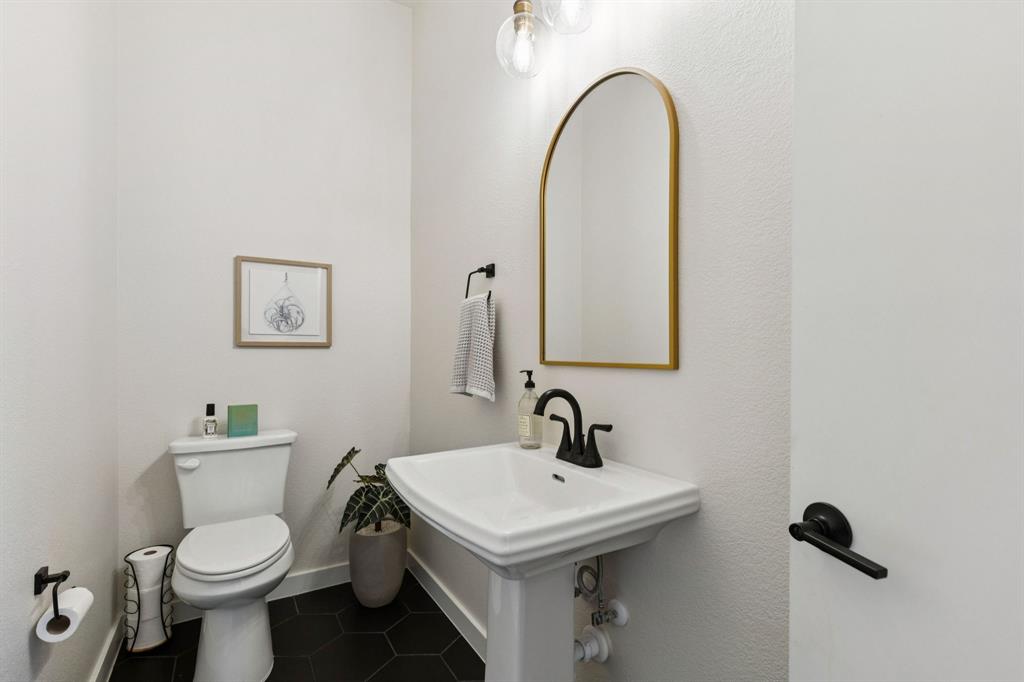 2291 Rook Drive Dallas, TX 75211 - Photo 11 of 26 a bathroom with a toilet sink and mirror