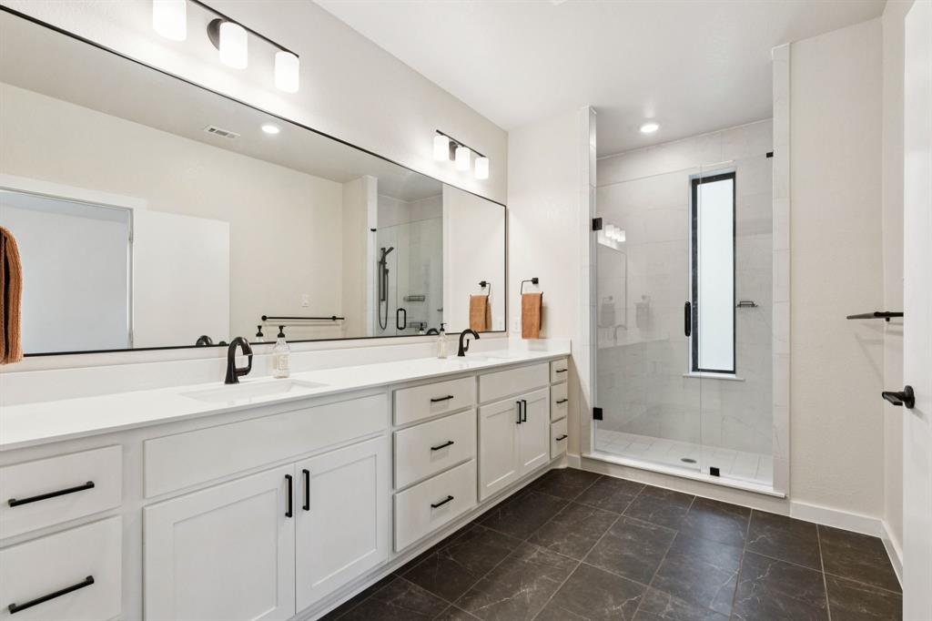 2291 Rook Drive Dallas, TX 75211 - Photo 14 of 26 a bathroom with double sink and a mirror