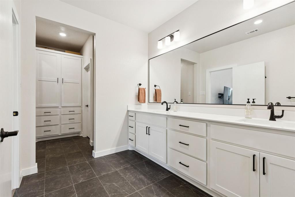 2291 Rook Drive Dallas, TX 75211 - Photo 16 of 26 a spacious bathroom with a granite countertop sink mirror and
