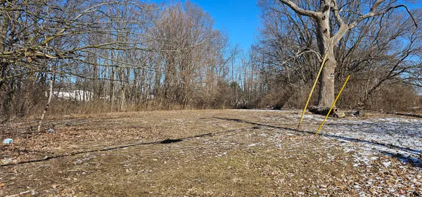 a view of yard covered with snow in front of house