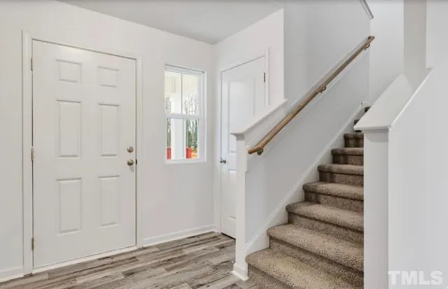 a view of entryway with bedroom and wooden floor