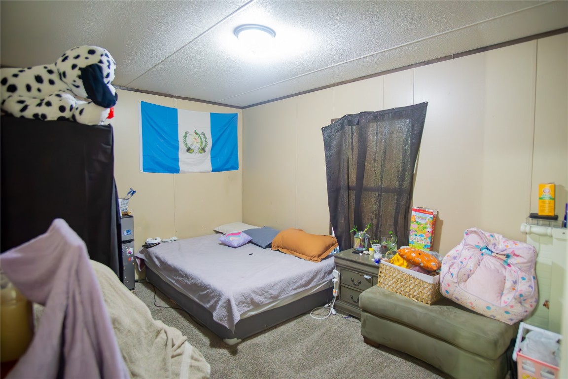 205 Arrowhead Cove Kyle, TX 78640 - Photo 13 of 20 a bedroom with a bed and ceiling fan