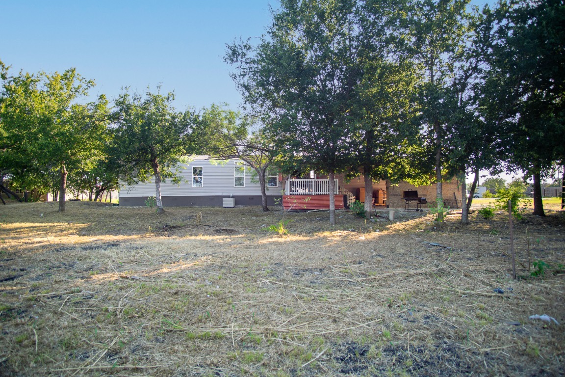 205 Arrowhead Cove Kyle, TX 78640 - Photo 17 of 20 a view of a house with a yard