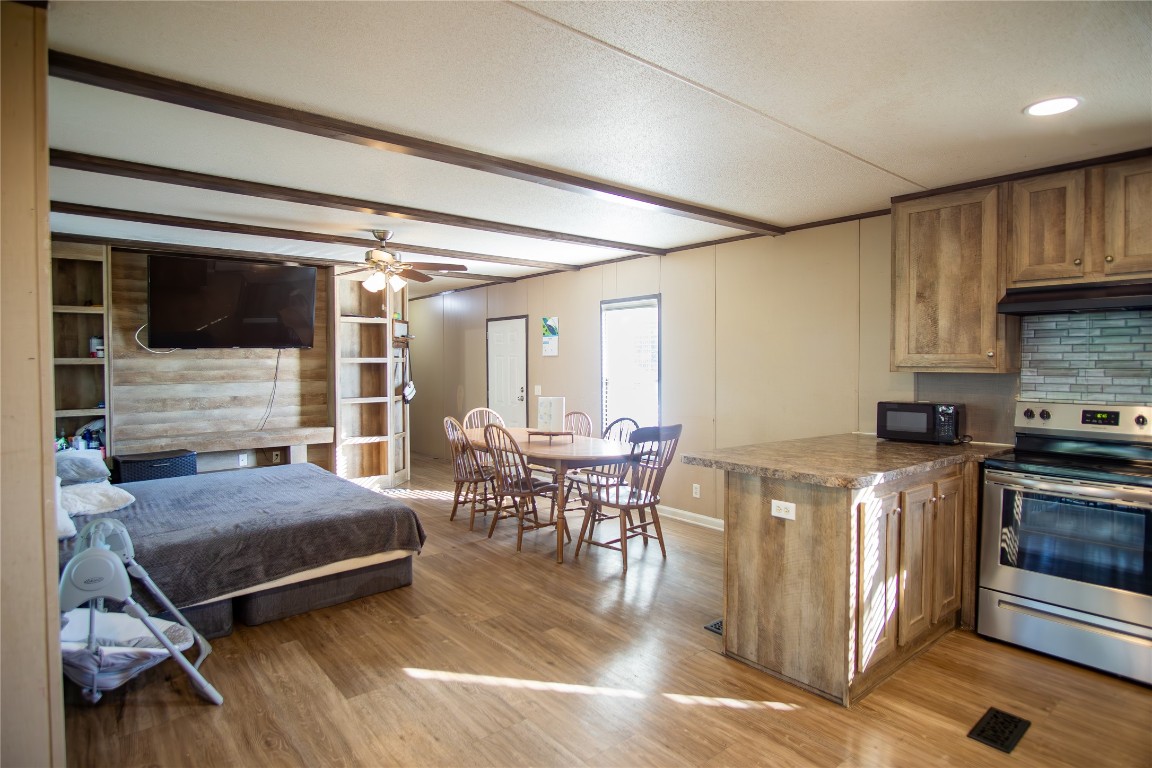 205 Arrowhead Cove Kyle, TX 78640 - Photo 5 of 20 a living room with stainless steel appliances furniture a rug and a kitchen view