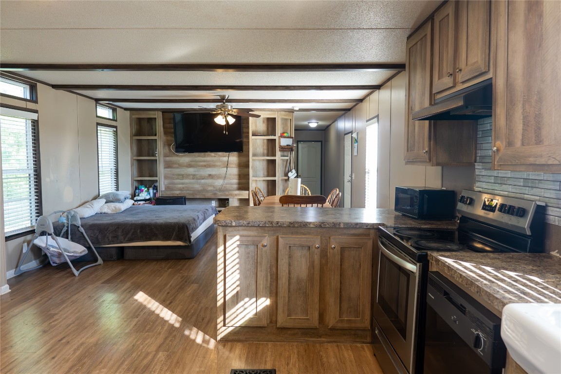 205 Arrowhead Cove Kyle, TX 78640 - Photo 6 of 20 a kitchen with stainless steel appliances granite countertop a stove and a sink