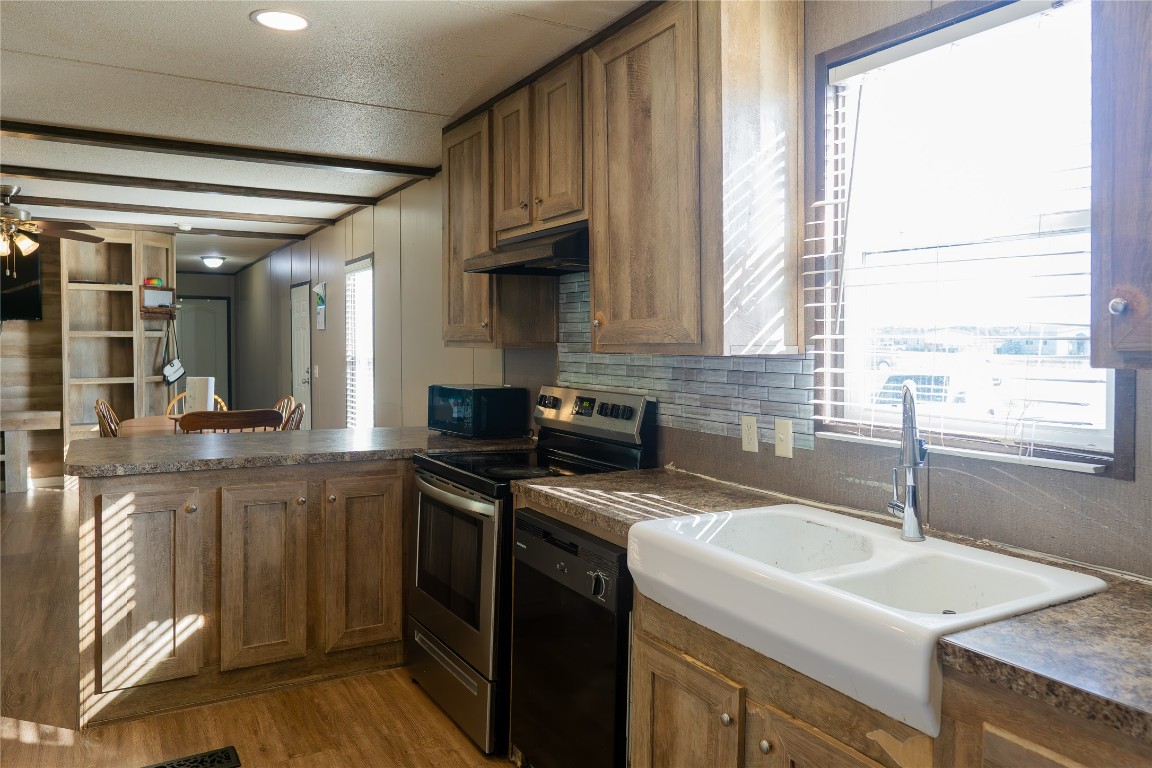 205 Arrowhead Cove Kyle, TX 78640 - Photo 7 of 20 a kitchen with a sink stove and cabinets