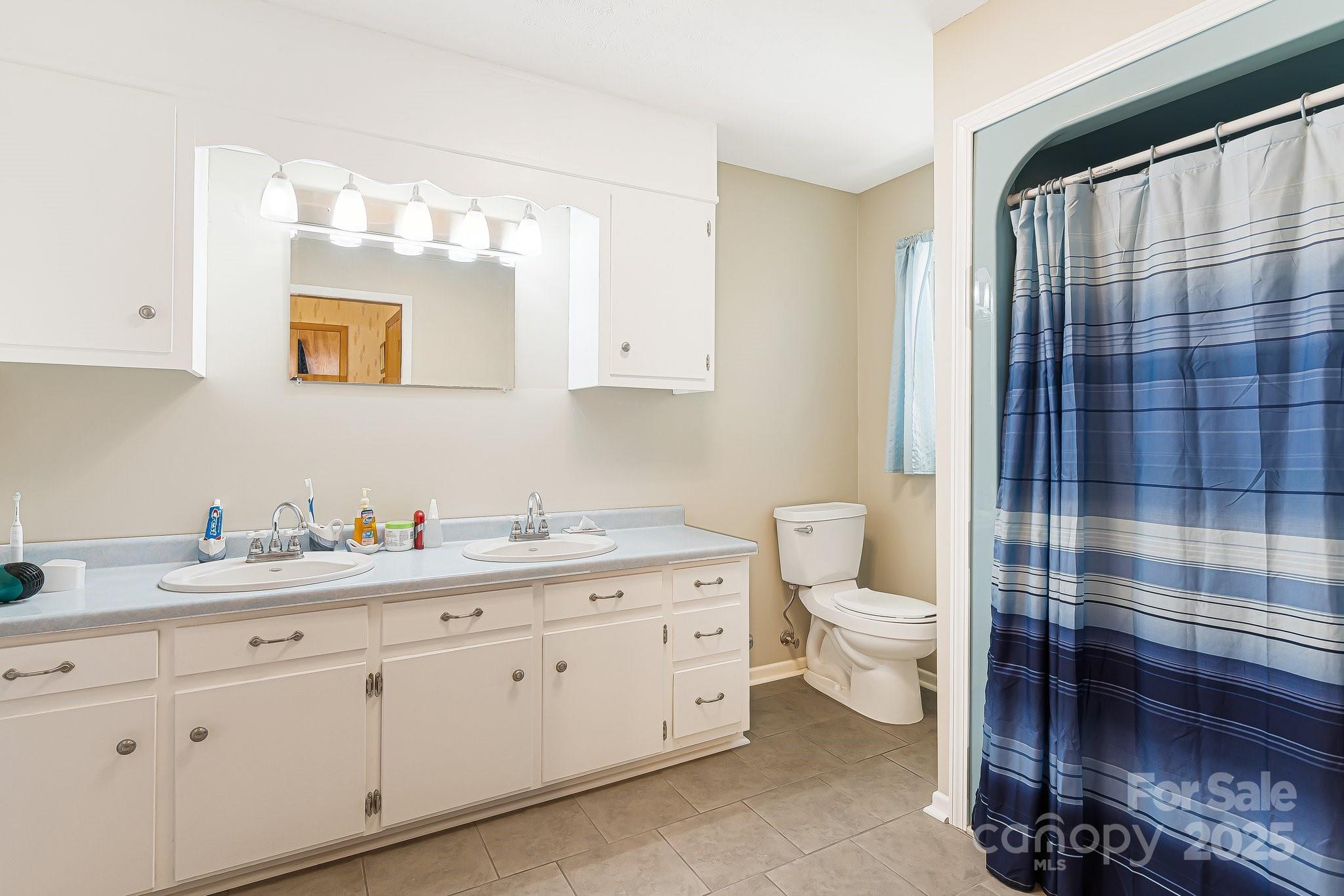 1361 Jack McKinney Road Rutherfordton, NC 28139 - Photo 34 of 46 a bathroom with a double vanity sink toilet and shower