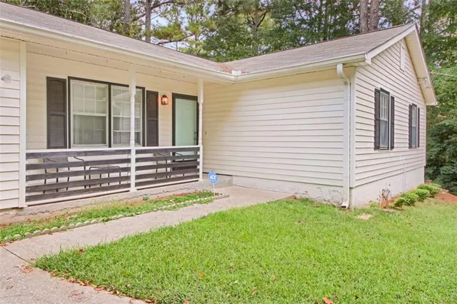 a view of a house with a small yard and a large window