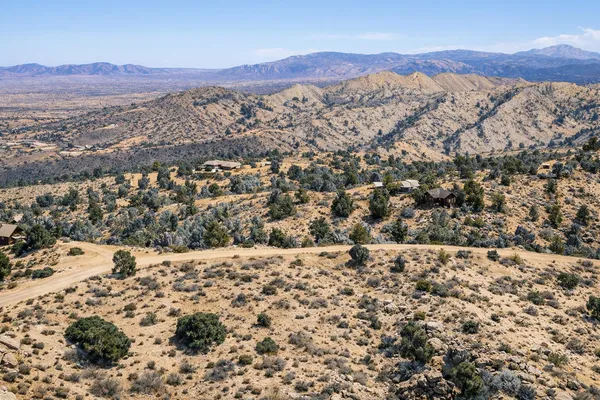 a view of a field with mountains in the background