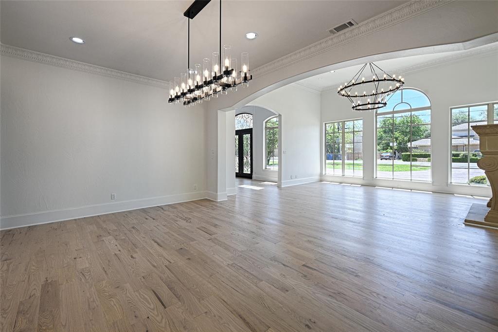 6301 Churchill Way Dallas, TX 75230 - Photo 11 of 40 an empty room with wooden floor and chandelier